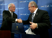 Larry Dicke, CalChamber Chief Financial Officer, presents a gift bag to José Guadalupe Osuna Millán, Governor of Baja California