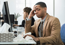 Colds, Flus, RSV: What Can California Employers Do? Sick Employee at Desk