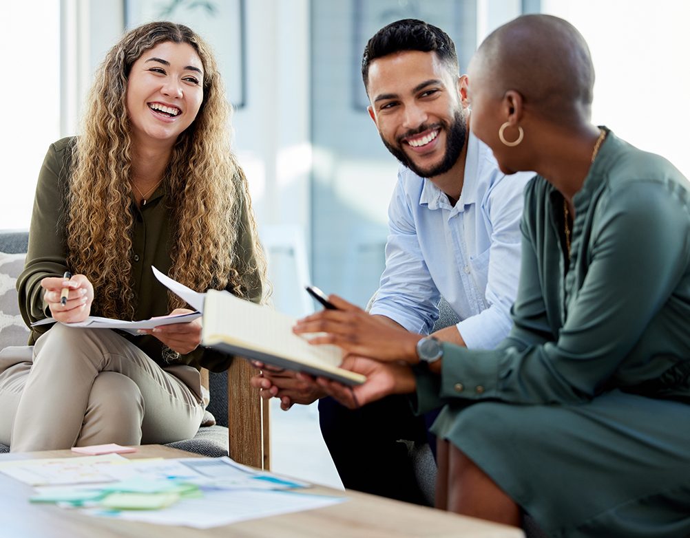 Happy business people smile during a planning meeting in a startup marketing agency office. Diversity, collaboration and teamwork in a healthy work environment in an international advertising company